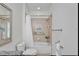 Cozy bathroom featuring a shower-tub combo with a white curtain, shelves, and neutral tones at 970 Pembroke Point Way, Sun City Center, FL 33573