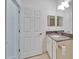 Well-lit bathroom featuring modern fixtures, granite countertop, and tiled flooring at 970 Pembroke Point Way, Sun City Center, FL 33573