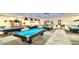 Spacious billiard room featuring multiple pool tables, offering a recreational space for residents and guests at 970 Pembroke Point Way, Sun City Center, FL 33573