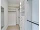 Well-organized walk-in closet with built-in shelving, drawers, and hanging rods for ample storage space at 970 Pembroke Point Way, Sun City Center, FL 33573