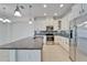 Bright kitchen featuring granite countertops, stainless steel appliances, and white cabinets for a modern touch at 970 Pembroke Point Way, Sun City Center, FL 33573