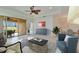 Bright living room with tray ceiling, neutral décor, and a seamless connection to the outdoor patio at 970 Pembroke Point Way, Sun City Center, FL 33573