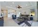 Bright living room with neutral décor, and a seamless connection to the adjacent rooms at 970 Pembroke Point Way, Sun City Center, FL 33573