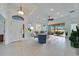 Bright living room featuring tile floors, high ceilings, neutral furniture, and sliding glass doors to the patio at 970 Pembroke Point Way, Sun City Center, FL 33573