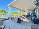 Beautiful outdoor patio with picturesque lake views and comfortable seating, perfect for dining al fresco at 970 Pembroke Point Way, Sun City Center, FL 33573