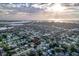 Aerial view of a neighborhood near the coast, with a focus on a house marked with a red target at 10350 54Th N Ave, St Petersburg, FL 33708
