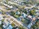 Expansive aerial view showcasing a residential area with mature trees, varied house designs, and streetscapes at 10350 54Th N Ave, St Petersburg, FL 33708