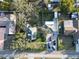 Aerial view showing a home's backyard, driveway, and surrounding neighborhood, framed by mature trees at 10350 54Th N Ave, St Petersburg, FL 33708