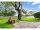 Spacious backyard featuring a stone patio, brick fireplace, and mature shade tree at 10350 54Th N Ave, St Petersburg, FL 33708