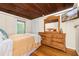 A cozy bedroom with a wooden dresser and wall-mounted TV at 10350 54Th N Ave, St Petersburg, FL 33708