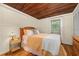 Charming bedroom featuring a wood-paneled ceiling and comfortable furnishings at 10350 54Th N Ave, St Petersburg, FL 33708