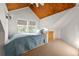 Upper level bedroom with a wood ceiling, dormer windows, and a cozy bed at 10350 54Th N Ave, St Petersburg, FL 33708