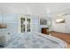 Comfortable bedroom with a queen bed, desk with chair, and ample natural light from the windows at 10350 54Th N Ave, St Petersburg, FL 33708