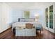 Bright bedroom with wooden floors, double closet, and a bed with a decorative trunk at the foot at 10350 54Th N Ave, St Petersburg, FL 33708