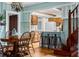 Cozy dining room with wooden table, chairs, and a view into the kitchen with breakfast bar at 10350 54Th N Ave, St Petersburg, FL 33708