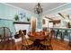 Inviting dining room with fireplace, round table, classic chairs, and bar access to the kitchen at 10350 54Th N Ave, St Petersburg, FL 33708