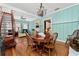 Inviting dining area showcasing wood floors, staircase, access to living area, and light blue walls at 10350 54Th N Ave, St Petersburg, FL 33708