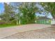 Long driveway leading to a two-story green home and detached garage at 10350 54Th N Ave, St Petersburg, FL 33708