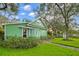 Charming green two-story home with lush landscaping and walkway at 10350 54Th N Ave, St Petersburg, FL 33708