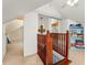 View of an upstairs hallway featuring a wood railing and carpeted floors at 10350 54Th N Ave, St Petersburg, FL 33708