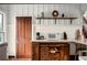 Bright kitchen featuring white countertops, wooden cabinets, vintage door, and rustic shelving at 10350 54Th N Ave, St Petersburg, FL 33708