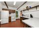 Spacious kitchen featuring white appliances, brick floors, wooden cabinets, and bright countertops at 10350 54Th N Ave, St Petersburg, FL 33708