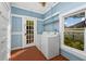 Bright laundry room featuring a washer, dryer, and a large window with a view at 10350 54Th N Ave, St Petersburg, FL 33708