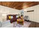 Inviting living room with a leather couch, area rug, and light wood floor in neutral tones at 10350 54Th N Ave, St Petersburg, FL 33708