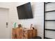 Modern living room featuring a flat screen TV, stylish wooden cabinet, and decorative accents against shiplap walls at 10350 54Th N Ave, St Petersburg, FL 33708