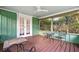 Covered porch with outdoor furniture and a ceiling fan at 10350 54Th N Ave, St Petersburg, FL 33708