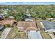 Aerial view of house with pool and lush trees at 1212 Markley Dr, Largo, FL 33770