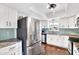 Modern kitchen with stainless steel appliances and light blue backsplash at 1212 Markley Dr, Largo, FL 33770