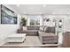 Relaxing living room with a gray sectional sofa and large windows at 1212 Markley Dr, Largo, FL 33770