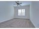 Spacious bedroom with ceiling fan and neutral carpeting at 13903 Natures Reserve Dr, Lithia, FL 33547