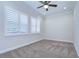Well-lit bedroom featuring two windows with shutters at 13903 Natures Reserve Dr, Lithia, FL 33547