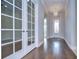 Elegant entry hall with hardwood floors and French doors at 13903 Natures Reserve Dr, Lithia, FL 33547