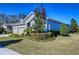 House exterior showcasing landscaping and a three-car garage at 13903 Natures Reserve Dr, Lithia, FL 33547