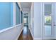 Long hallway with hardwood floors and access to backyard at 13903 Natures Reserve Dr, Lithia, FL 33547