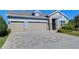 Two-story house with a two-car garage and landscaping at 13903 Natures Reserve Dr, Lithia, FL 33547