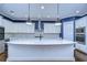 Gourmet kitchen with white cabinets, large island, and quartz countertops at 13903 Natures Reserve Dr, Lithia, FL 33547