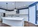 Modern kitchen with white cabinets, a large island, and quartz countertops at 13903 Natures Reserve Dr, Lithia, FL 33547