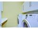 Laundry room with washer, dryer, and upper cabinets at 13903 Natures Reserve Dr, Lithia, FL 33547