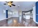 Open living room featuring hardwood floors and a modern kitchen at 13903 Natures Reserve Dr, Lithia, FL 33547