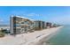 Aerial view of beachfront high-rise building with ocean and beach at 15462 Gulf Blvd # 603, Madeira Beach, FL 33708