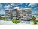 Aerial view of beachfront high-rise building with pool at 15462 Gulf Blvd # 603, Madeira Beach, FL 33708