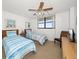 Guest bedroom with twin beds, ocean view, and ceiling fan at 15462 Gulf Blvd # 603, Madeira Beach, FL 33708