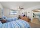 Guest bedroom with twin beds, ocean view, and kitchen access at 15462 Gulf Blvd # 603, Madeira Beach, FL 33708