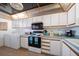 Bright kitchen features white cabinetry, appliances, and a washer and dryer at 15462 Gulf Blvd # 603, Madeira Beach, FL 33708