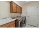 Laundry room with washer, dryer, cabinets, and sink at 207 Winding River Trl, Bradenton, FL 34212