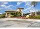 Tennis center with large yellow tennis ball and lush landscaping at 207 Winding River Trl, Bradenton, FL 34212